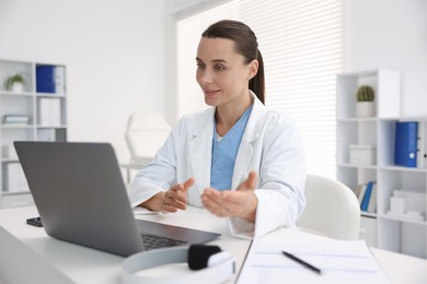 Photo of Doctor having online consultation via laptop in clinic