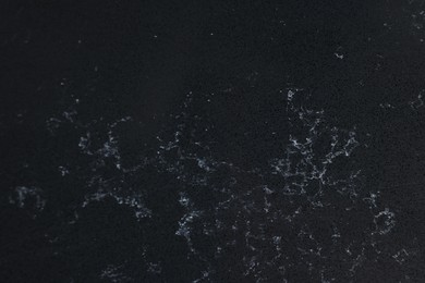 Photo of Texture of black marble surface as background, top view