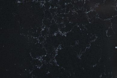 Photo of Texture of black marble surface as background, top view