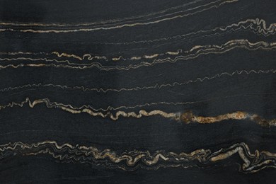 Photo of Texture of dark marble surface as background, top view