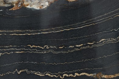 Photo of Texture of dark marble surface as background, top view