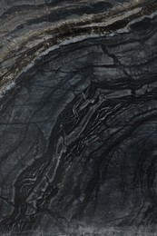 Photo of Texture of dark marble surface as background, top view