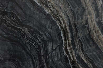 Photo of Texture of dark marble surface as background, top view