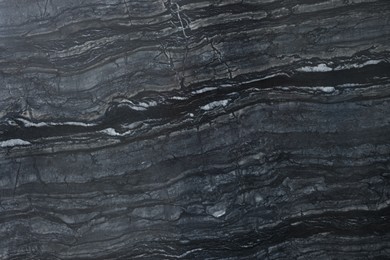 Photo of Texture of dark marble surface as background, top view
