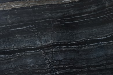 Photo of Texture of dark marble surface as background, top view