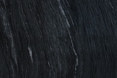 Photo of Texture of dark marble surface as background, top view