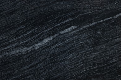 Photo of Texture of dark marble surface as background, top view