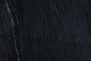 Photo of Texture of dark marble surface as background, top view