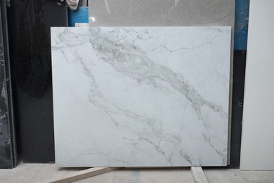 Photo of Different samples of marble tiles on display in store