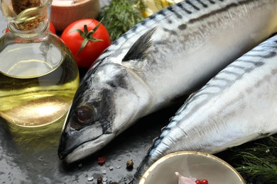Photo of Fresh raw mackerels and spices on table, closeup. Seafood delicacies