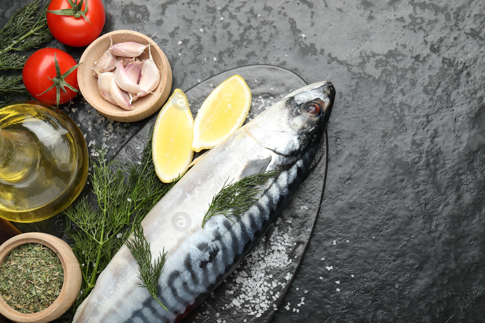 Seafood delicacies. Fresh raw mackerel and spices on black table, flat lay. Space for text Photo of Seafood delicacies. Fresh raw mackerel and spices on black table, flat lay. Space for text