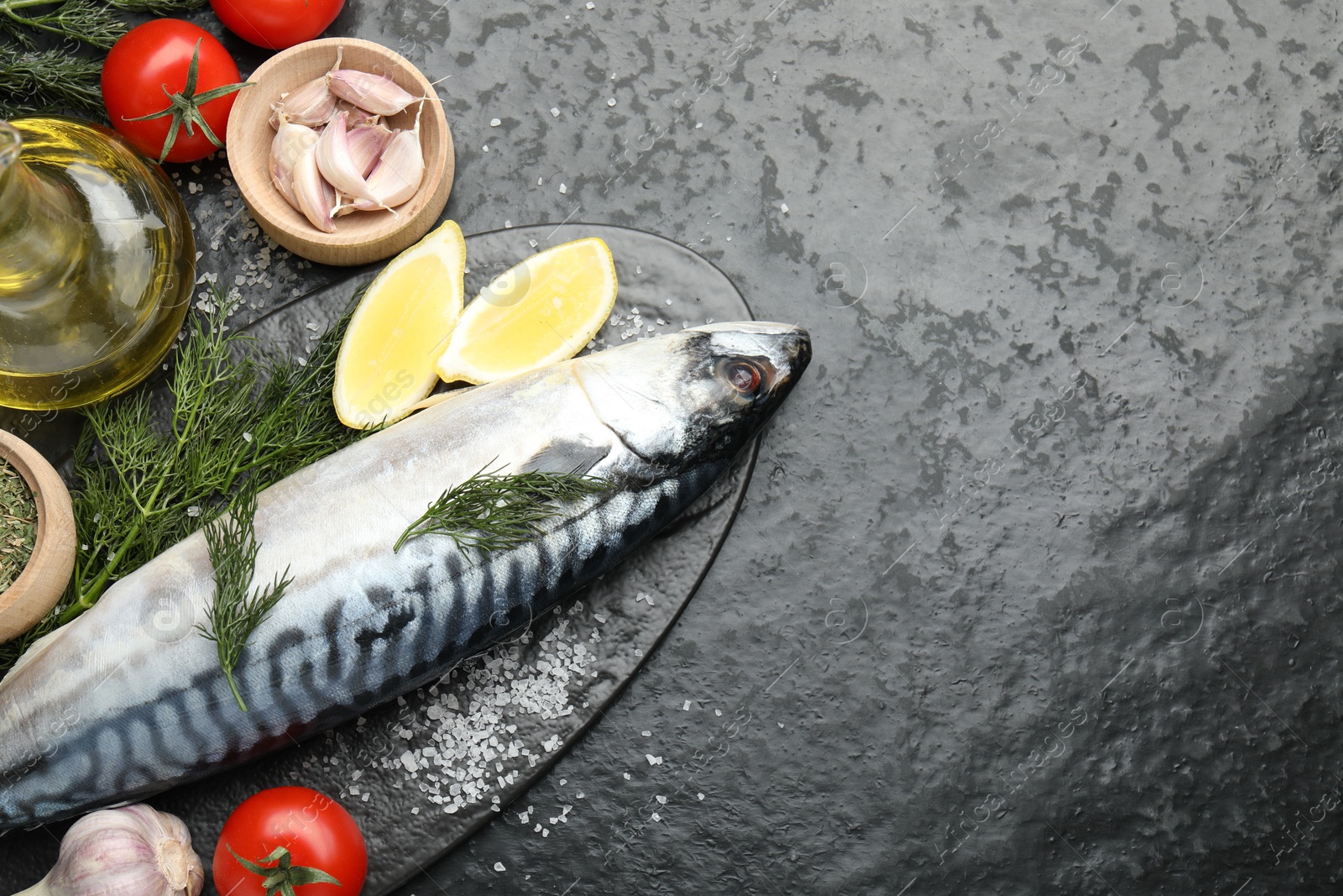 Seafood delicacies. Fresh raw mackerel and spices on black table, flat lay. Space for text Photo of Seafood delicacies. Fresh raw mackerel and spices on black table, flat lay. Space for text