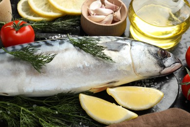 Photo of Fresh raw mackerel and spices on table, closeup. Seafood delicacies