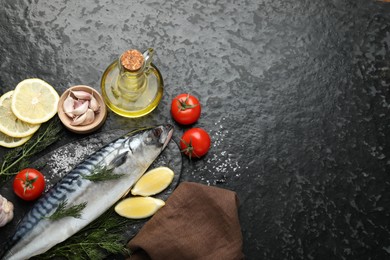 Photo of Seafood delicacies. Fresh raw mackerel and spices on black table, flat lay. Space for text