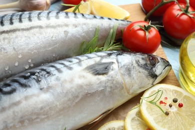 Photo of Fresh raw mackerels and spices on table, closeup. Seafood delicacies