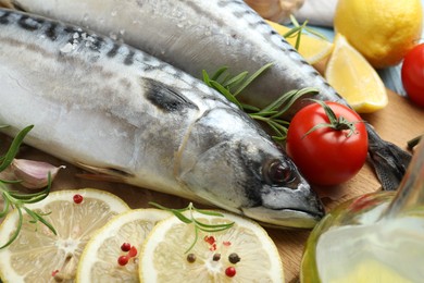 Photo of Fresh raw mackerels and spices on table, closeup. Seafood delicacies