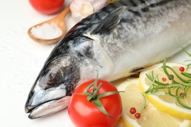 Photo of Fresh raw mackerel and spices on white table, closeup. Seafood delicacies