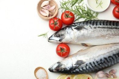 Photo of Seafood delicacies. Fresh raw mackerels and spices on white table, flat lay. Space for text