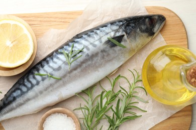 Photo of Fresh raw mackerel and spices on table, flat lay. Seafood delicacies