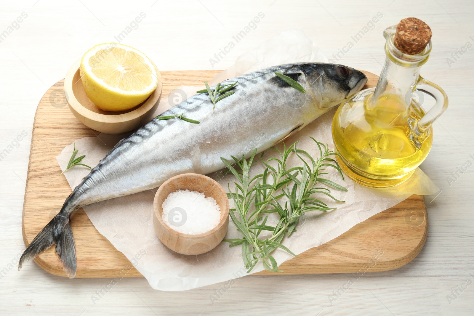 Fresh raw mackerel and spices on light wooden table, above view. Seafood delicacies Photo of Fresh raw mackerel and spices on light wooden table, above view. Seafood delicacies