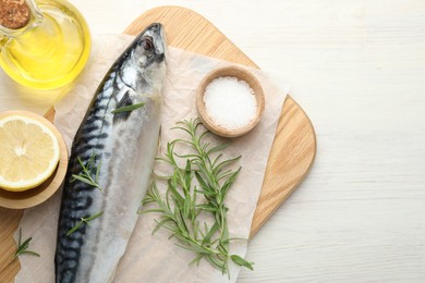 Photo of Seafood delicacies. Fresh raw mackerel and spices on light wooden table, flat lay. Space for text