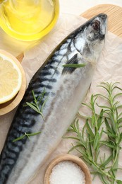 Photo of Fresh raw mackerel and spices on table, flat lay. Seafood delicacies