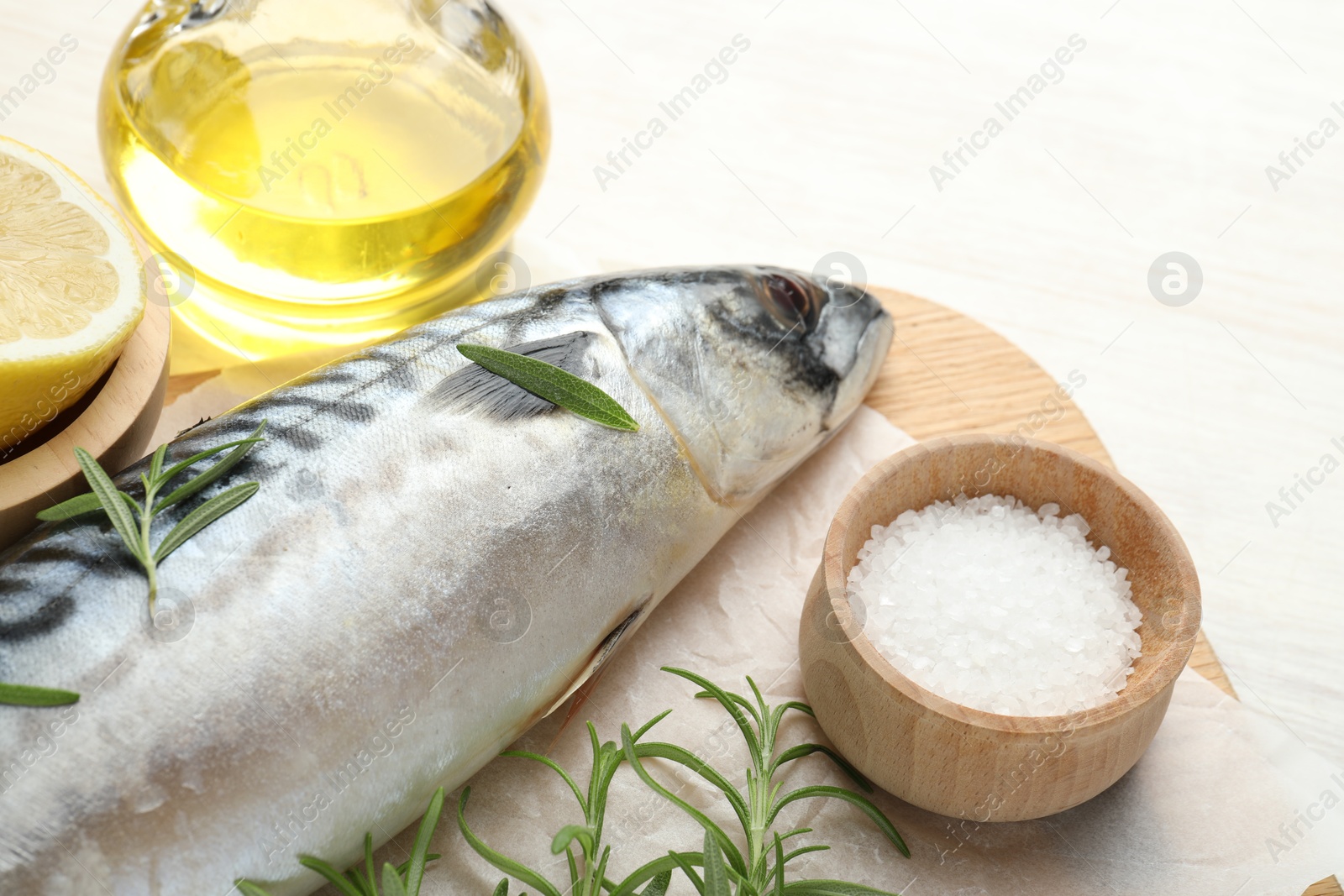 Fresh raw mackerel and spices on light wooden table, closeup. Seafood delicacies Photo of Fresh raw mackerel and spices on light wooden table, closeup. Seafood delicacies