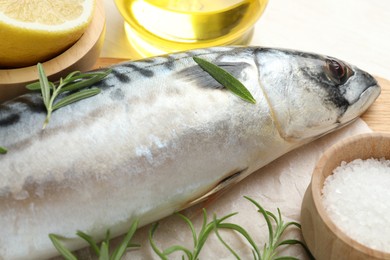 Photo of Fresh raw mackerel and spices on table, closeup. Seafood delicacies