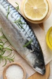 Photo of Fresh raw mackerel and spices on table, flat lay. Seafood delicacies