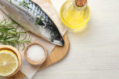 Photo of Seafood delicacies. Fresh raw mackerel and spices on light wooden table, flat lay. Space for text