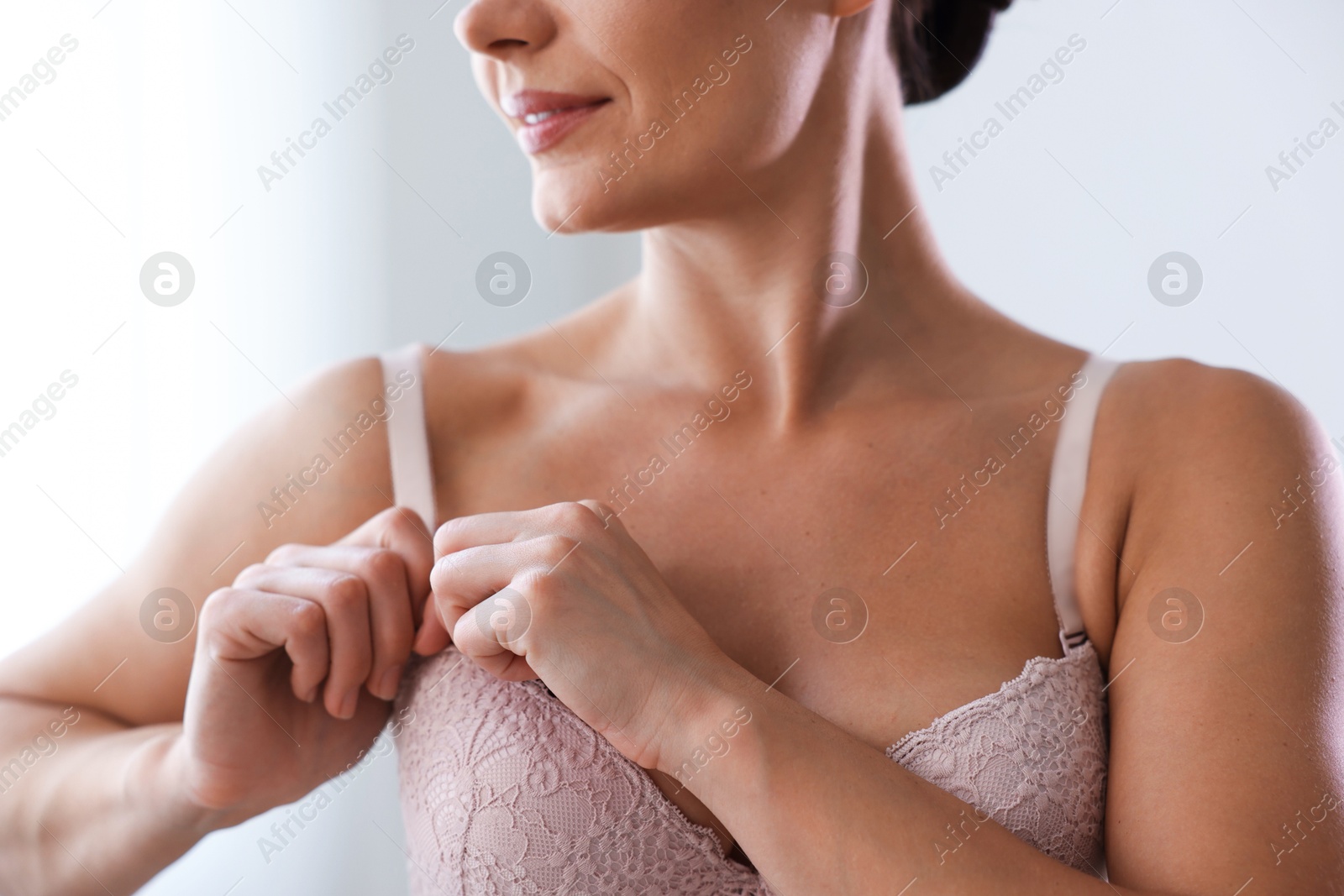 Woman wearing beautiful bra at home, closeup Photo of Woman wearing beautiful bra at home, closeup