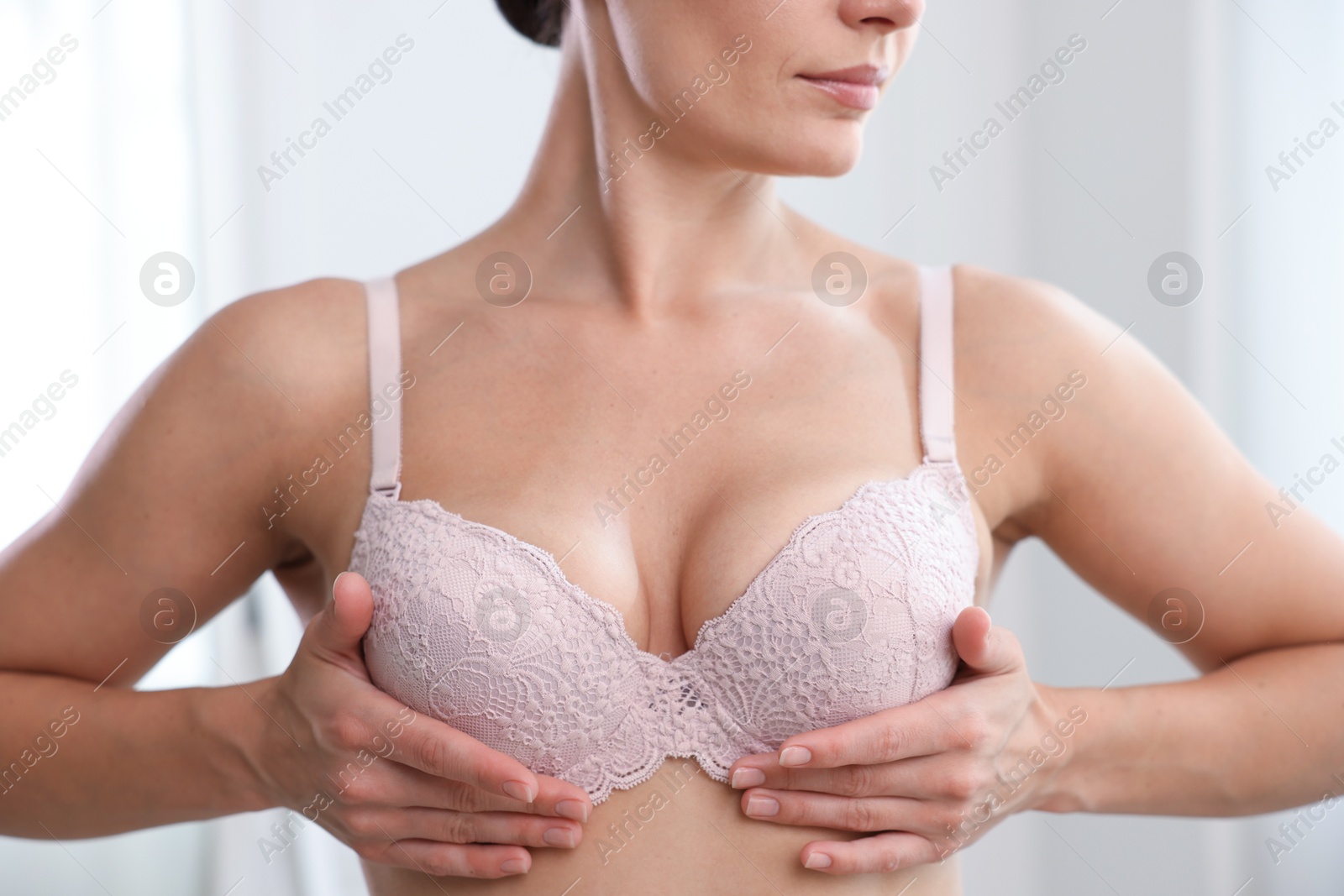 Woman wearing beautiful bra at home, closeup Photo of Woman wearing beautiful bra at home, closeup