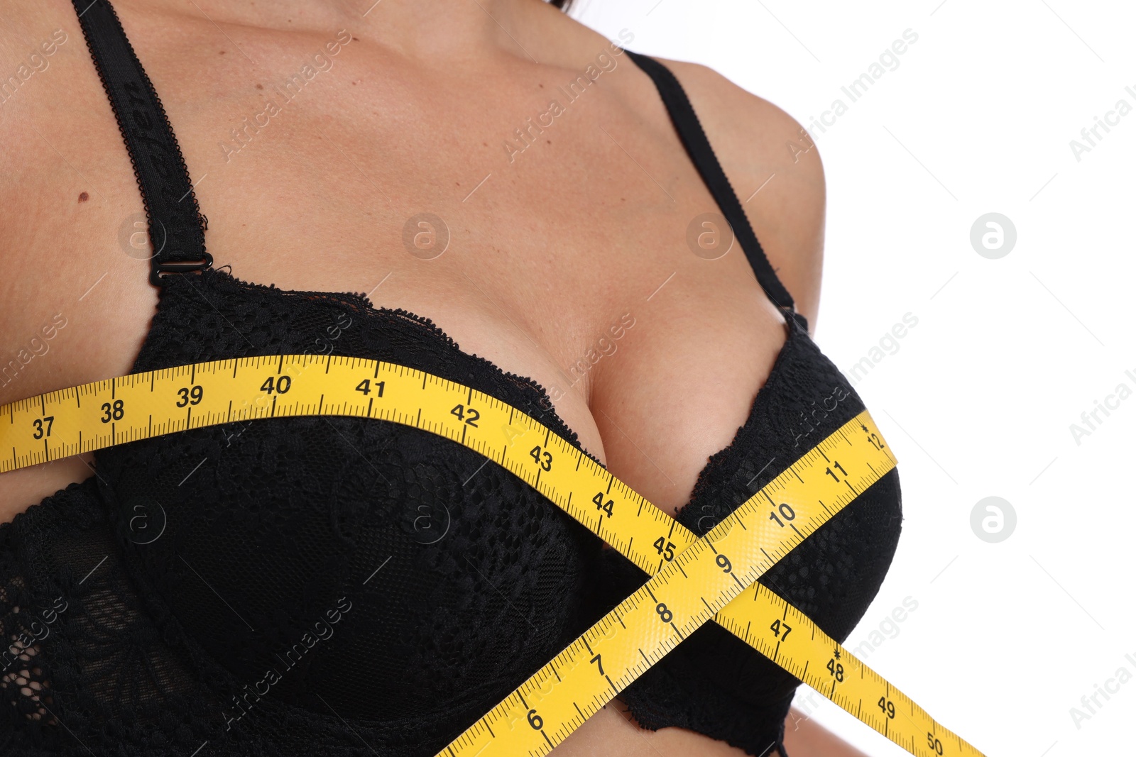 Woman in beautiful bra measuring breast circumference on white background, closeup Photo of Woman in beautiful bra measuring breast circumference on white background, closeup