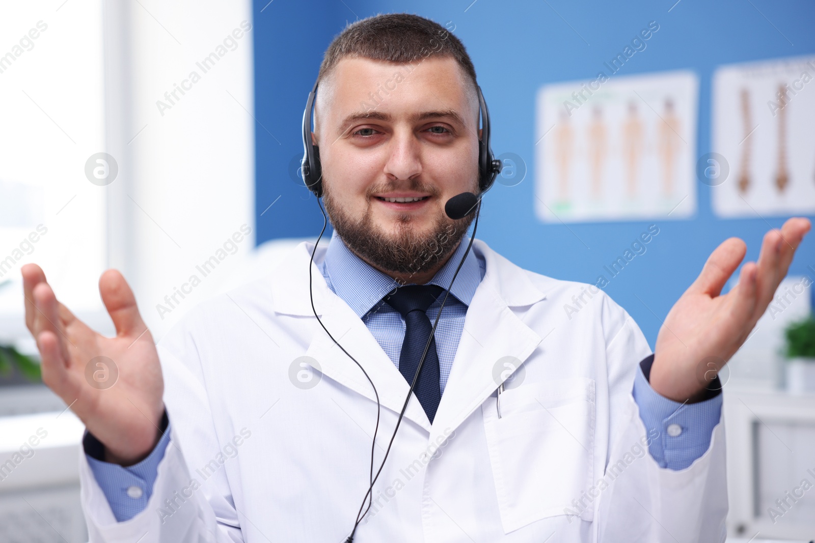 Doctor with headset in clinic. Online medical consultation Photo of Doctor with headset in clinic. Online medical consultation