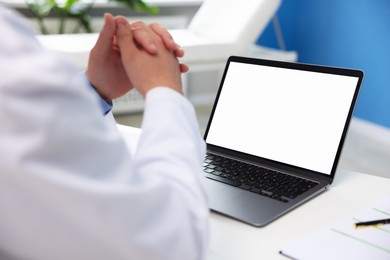 Photo of Doctor using laptop in clinic, closeup. Online medical consultation