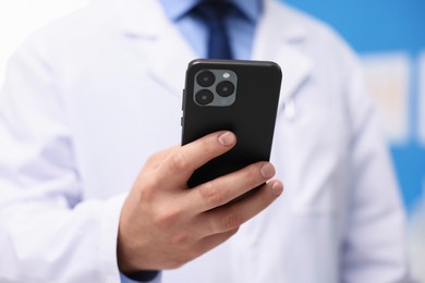Photo of Doctor with smartphone in clinic, closeup. Online medical consultation