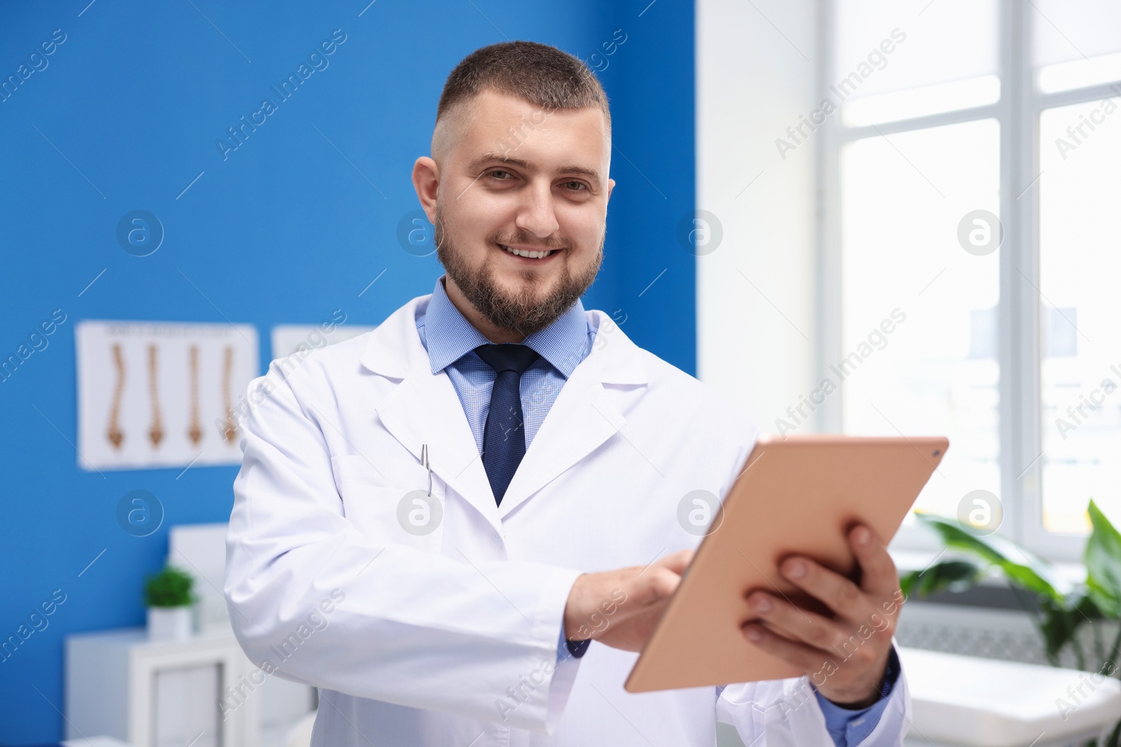 Doctor with tablet in clinic. Online medical consultation Photo of Doctor with tablet in clinic. Online medical consultation