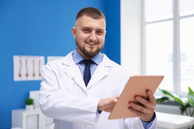 Photo of Doctor with tablet in clinic. Online medical consultation