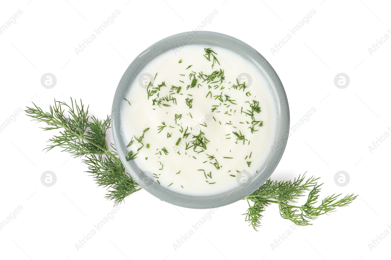 Delicious yogurt in bowl and dill isolated on white, top view Photo of Delicious yogurt in bowl and dill isolated on white, top view