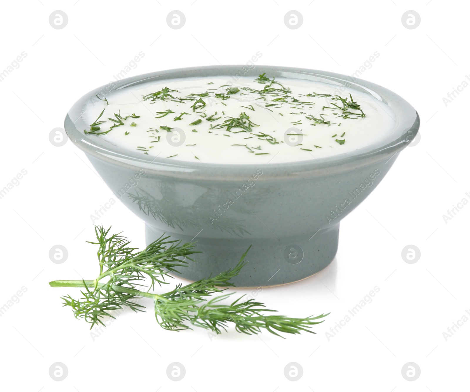 Photo of Delicious yogurt in bowl and dill isolated on white