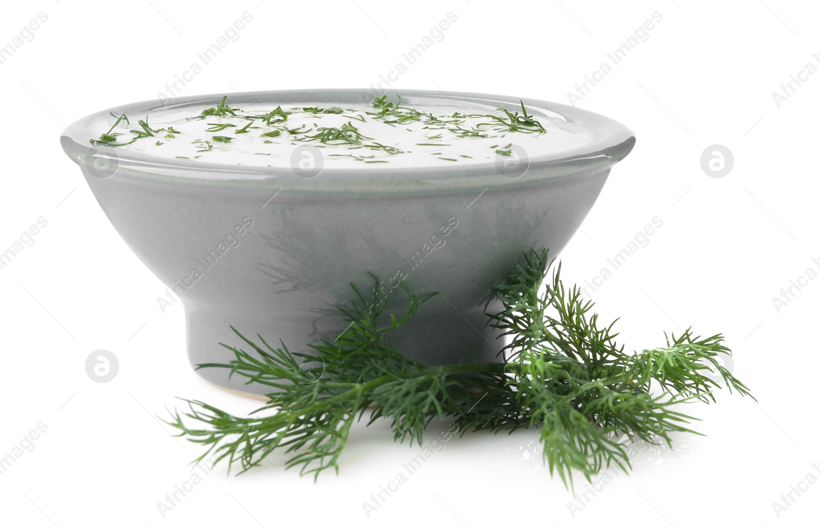 Photo of Delicious yogurt in bowl and dill isolated on white