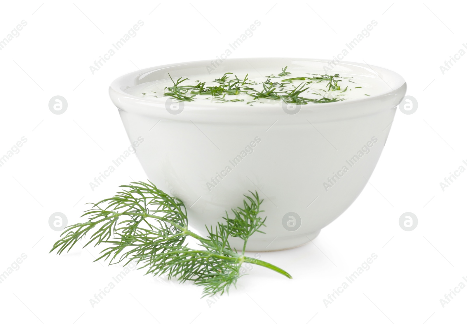 Photo of Delicious yogurt in bowl and dill isolated on white