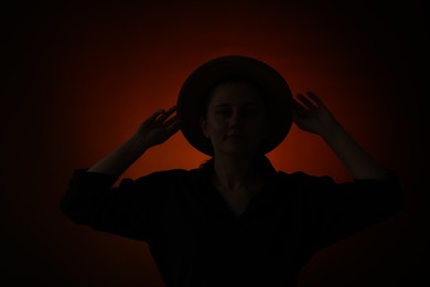 Photo of Silhouette of woman posing on dark gradient background