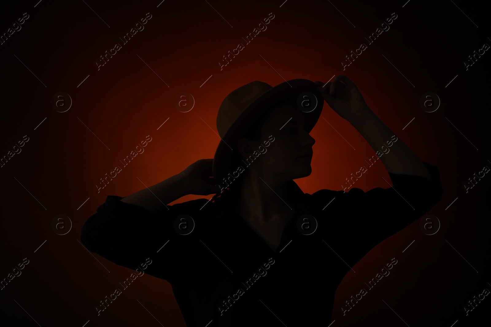 Photo of Silhouette of woman posing on dark gradient background