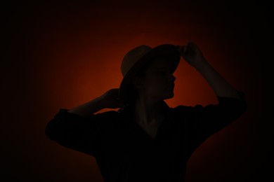 Photo of Silhouette of woman posing on dark gradient background