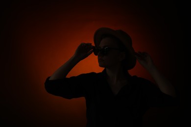 Photo of Silhouette of woman posing on dark gradient background
