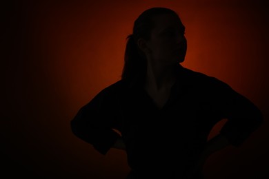 Photo of Silhouette of woman posing on dark gradient background