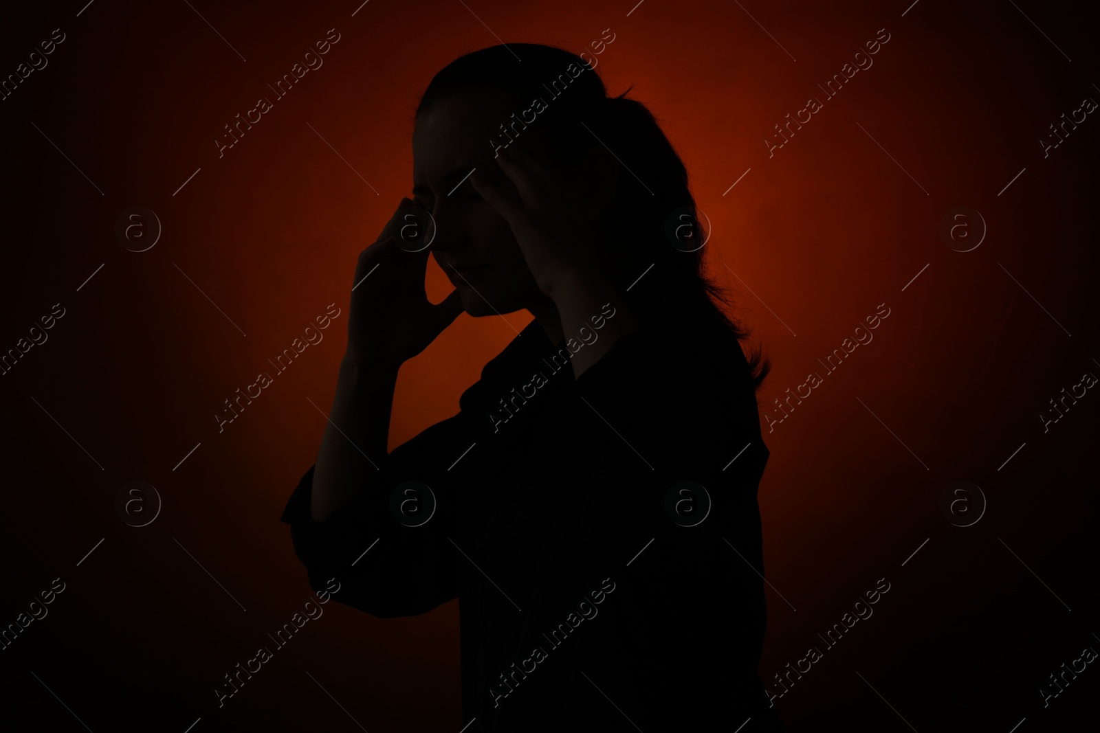 Photo of Silhouette of woman posing on dark gradient background