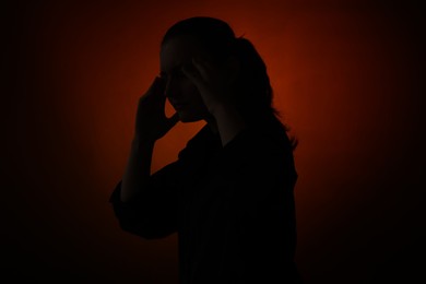 Photo of Silhouette of woman posing on dark gradient background