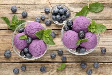 Photo of Tasty sorbet with blueberries and mint in dessert bowls on wooden table, flat lay